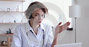 Serious young female medical worker giving professional consultation online.