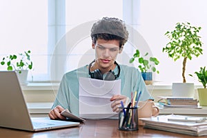 Serious young guy reading letter, paper document