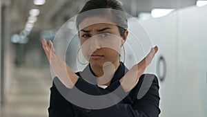 Portrait of Serious Young Indian Businesswoman saying No by Arms Crossed