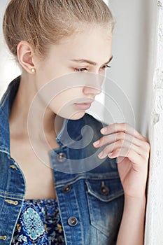 Serious young lady in jeans jacket.