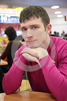 Serious young man in cafe