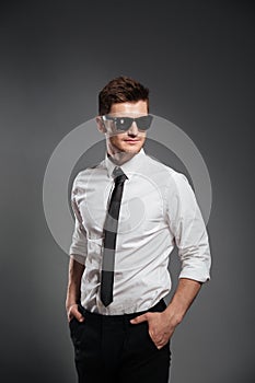 Serious young man dressed in formalwear