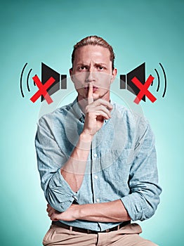 The serious young man over blue background