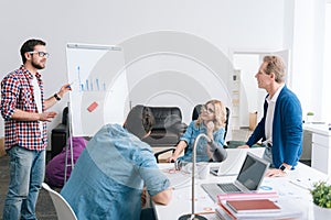 Serious young man presenting a diagram