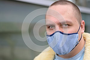 Serious young man wearing a face mask