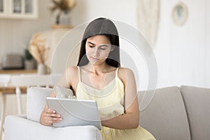 Serious young 25s pretty woman use modern digital tablet