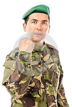 Serious young soldier with arm raised showing his fist