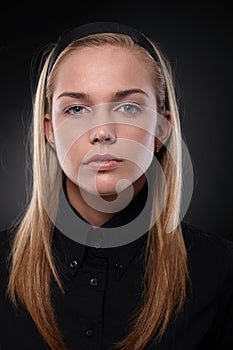 Serious young woman in black