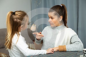 Serious young woman discuss conflict with small daughter