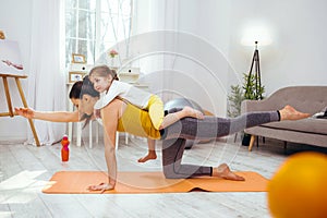 Serious young woman doing a physical exercise