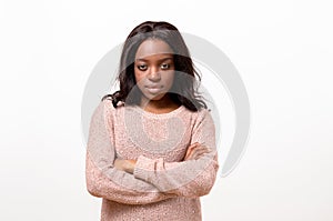 Serious young woman standing with folded arms