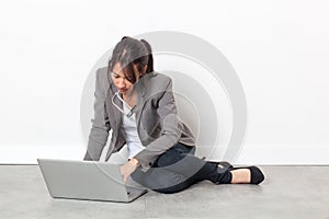 Serious young woman working on her laptop relaxing for inspiration