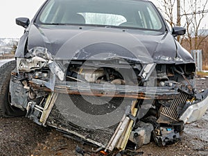 Seriously damaged car near roadside