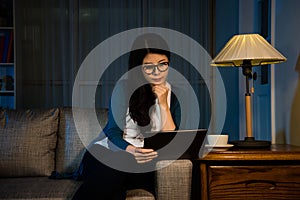 Seriously woman watching digital tablet screen