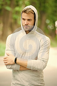 Seriousness and masculinity. sportswear fashion. sportsman relax after training outdoor. handsome unshaven man in hood