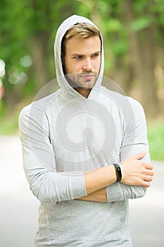Seriousness and masculinity. sportswear fashion. sportsman relax after training outdoor. handsome unshaven man in hood photo