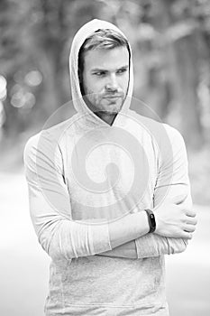 Seriousness and masculinity. sportswear fashion. sportsman relax after training outdoor. handsome unshaven man in hood photo