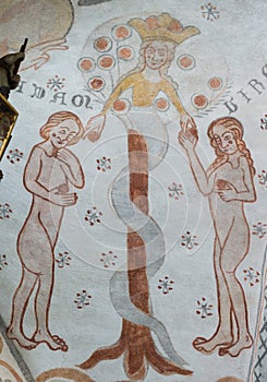 The serpent gives the forbidden fruit to Adam and Eve, a gothic