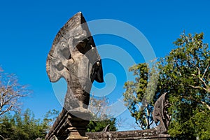 Serpent-like snake creature Phaya Naga statue in khmer ruins wat