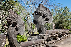 Serpent-like snake creature Phaya Naga statue in khmer ruins wat