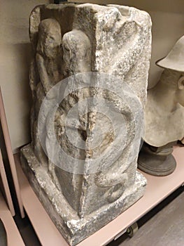 Serpent symbol on antique pillar with lowers on other side