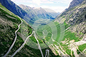 A serpentine mountain road at Trollstigen with the Trollveggen and Romsdalen valley in the background