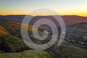 Serra da Freita drone aerial view in Arouca Geopark road with wind turbines at sunset, in Portugal