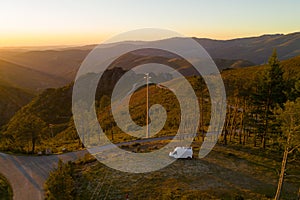 Serra da Freita drone aerial view of a camper van in Arouca Geopark at sunset, in Portugal