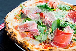 Serrano ham pizza. Neapolitan pizza made with baked vegetables and serrano ham. Italian vegetarian recipe.