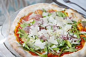 Serrano ham pizza. Neapolitan pizza made with baked vegetables and serrano ham. Italian vegetarian recipe.