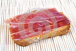 Serrano ham on toasted bread. Jabugo. Spanish tapa.