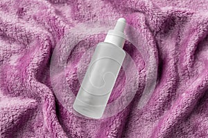 Serum with collagen and peptides cozy flat lay on pink cozy plush fuzzy fabric. Hyaluronic acid tincture, mockup. Home