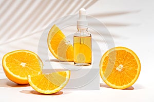 Serum oil vitamin C pipette dropper bottle on white podium copy space skin care beauty product. Anti aging antioxidant