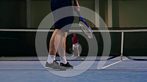 Serve by professional tennis player. Tennis serve indoor of tenis hall. Man on serve with tenis racket and dressed in