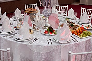 Served for a banquet table. Wine glasses with napkins, glasses.