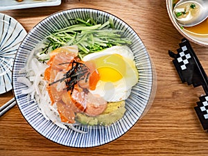 Served bowl with bibimbap with salmon sashimi