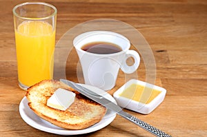 Served breakfast: coffee, toasts with butter, jam and orange juice