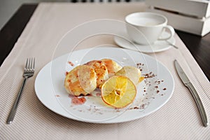 Served breakfast in the restaurant. Cottage cheese pancakes with orange ringlets and coffee