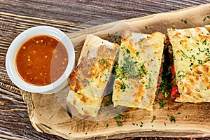 Served burito and red sauce.