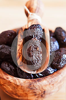 Served dried black olives in wooden olive bowl