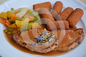 Served Pork Cutlet With Fried Potato Croquettes photo