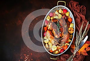 Served roasted Thanksgiving Turkey with vegetables on brown rustic background.