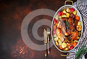 Served roasted Thanksgiving Turkey with vegetables on brown rustic background.
