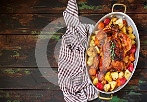 Served roasted Thanksgiving Turkey with vegetables on rustic background.