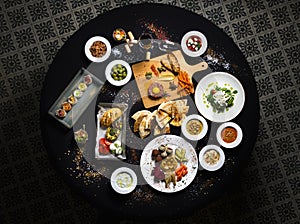 Served round table, Turkish and buckwheat dishes served table top view.