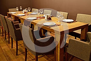 Served table with armchairs around in