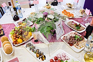 Served table at the Banquet. Fruits, snacks, delicacies and flowers in the restaurant. Solemn event or wedding