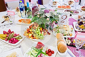 Served table at the Banquet. Fruits, snacks, delicacies and flowers in the restaurant. Solemn event or wedding