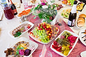 Served table at the Banquet. Fruits, snacks, delicacies and flowers in the restaurant. Solemn event or wedding
