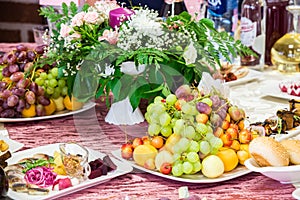 Served table at the Banquet. Fruits, snacks, delicacies and flowers in the restaurant. Solemn event or wedding